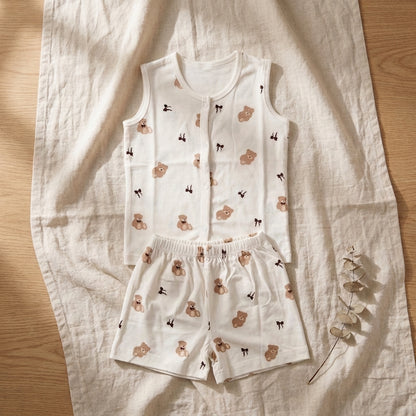 Baby bamboo jabla and shorts with teddy bear print laid flat on a cloth with decorative elements